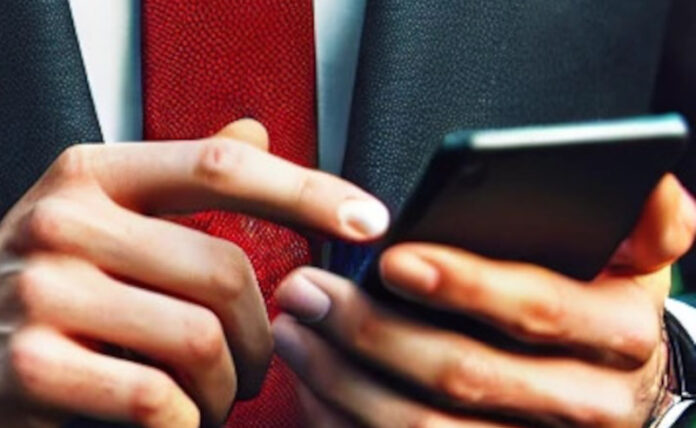 blue suit red tie wearing man using his phone to post something