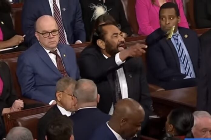 Rep. Al Green (D-TX) disrupts President Donald Trump's speech to Congress on March 4, 2025, before being removed from the chamber. The incident highlighted the deep partisan divide during the historic address.